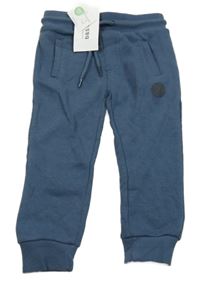 Nové - tmavomodré tepláky se skateboardem Vertbaudet