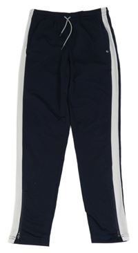 Tmavomodré sportovní tepláky s pruhem TCM