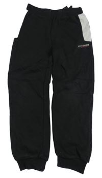 Černo-světlešedé tepláky s logem MCKENZIE