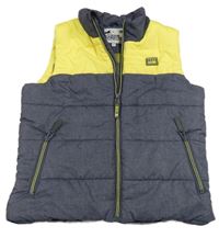 Tmavomodro-žlutá melírovaná prošívaná šusťáková zateplená vesta s nášivkou M&S