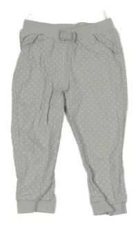 Šedé puntíkaté tepláky s mašlí a volánky C&A